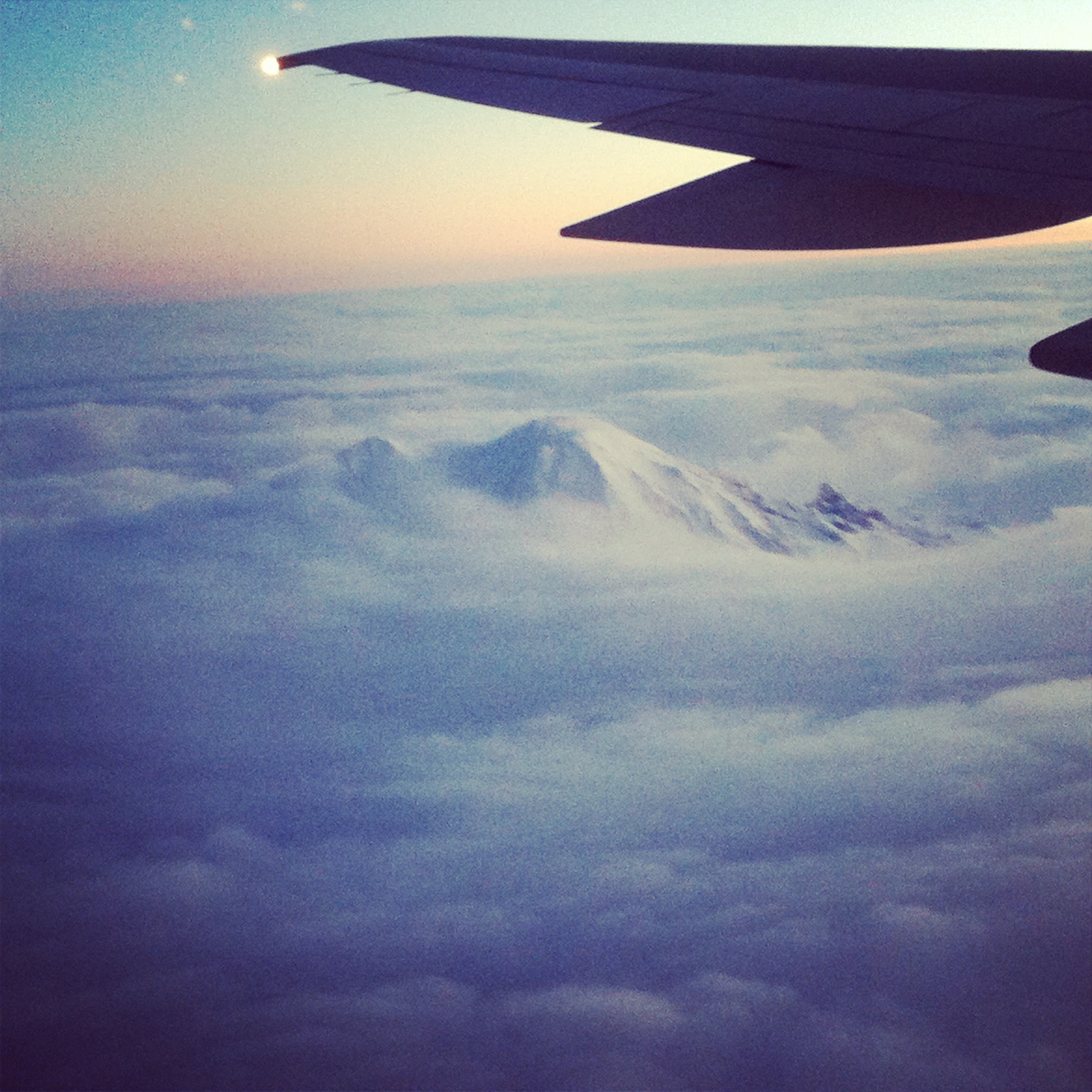 Cloud waves over Mount Rainier at sunrise.