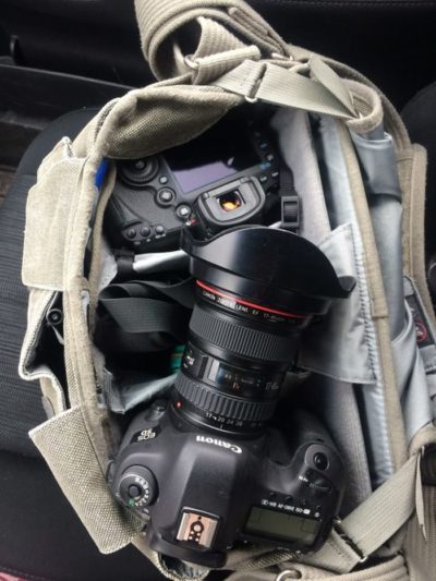 Two Canon DSLR cameras sitting in a camera bag.